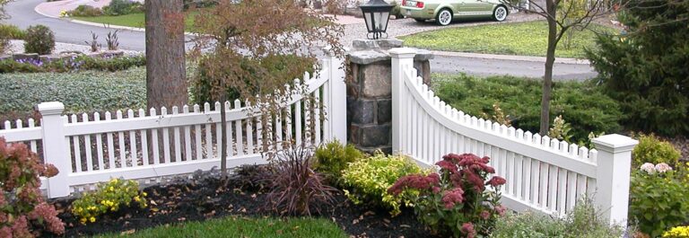 Curved Top Vinyl Picket Fence Accent at stone pillar